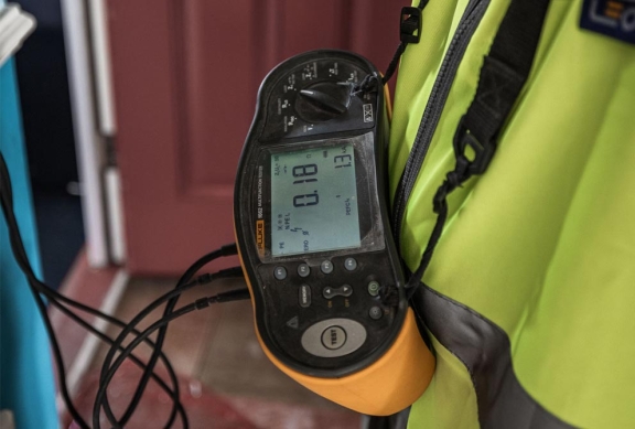 A close up of electrical testing equipment used during a home inspection people onsite