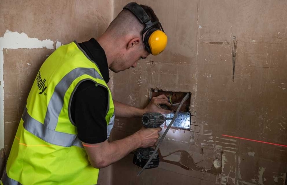 A Connolly electrician testing an electrical point during a home refurbishment