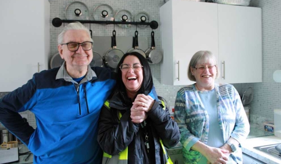 A resident couple sharing a light hearted moment with a Connolly worker