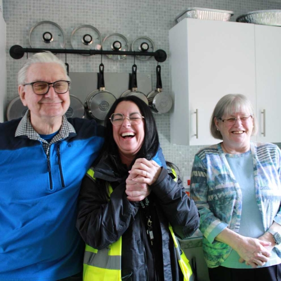 A resident couple sharing a light hearted moment with a Connolly worker