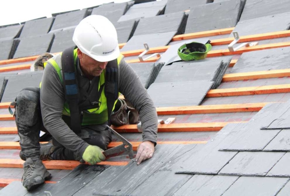 Connolly roofers fitting slate tiles on a residential roof