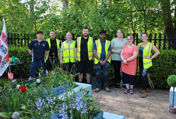 Connolly volunteers and residents gathered beside a planted community garden social value