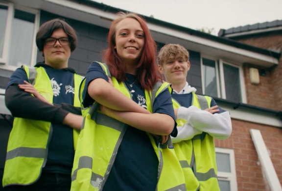 Three young Connolly apprentices posing outside in high visibility vests