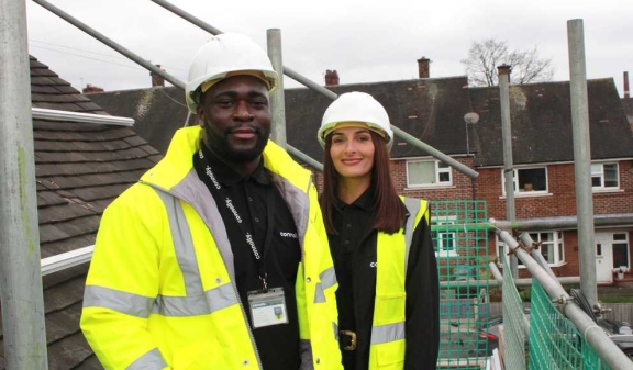 Two Connolly colleagues wearing hard hats on residential scaffolding